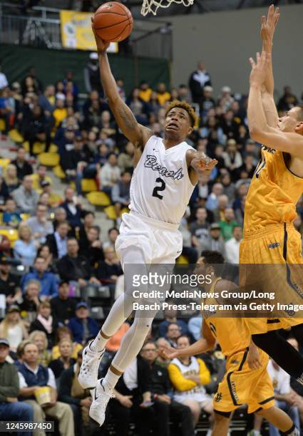 January 14: Long Beach State's Nick Faust takes the ball in against UC Irvine's Luke Nelson in a Big West Conference basketball game at the Pyramid...