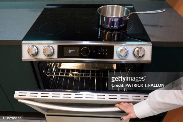 Product expert demonstrates the oven beneath an electric induction stove cooktop during a preview of Samsung Electronics Co.s Bespoke Home appliances...