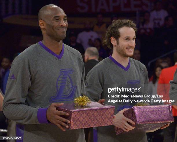 December 25: Los Angeles Lakers forward Kobe Bryant Los Angeles Lakers guard Marcelo Huertas get ready to give the gift of shoes before the game. The...