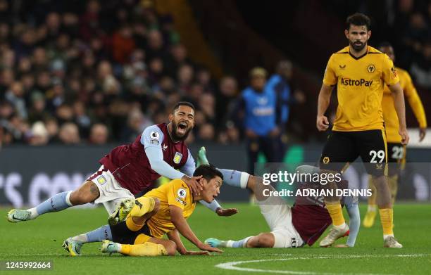 Wolverhampton Wanderers' South Korean striker Hwang Hee-chan fouls Aston Villa's Brazilian midfielder Douglas Luiz during the English Premier League...