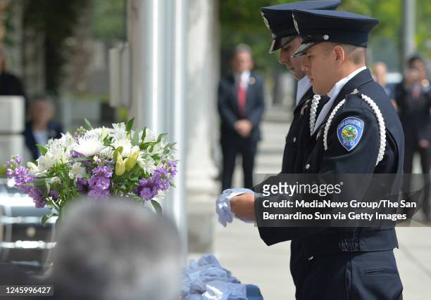 May 19: San Bernardino Police officers remove a single white glove after the names of fallen officers were read aloud during the Countywide Officer...