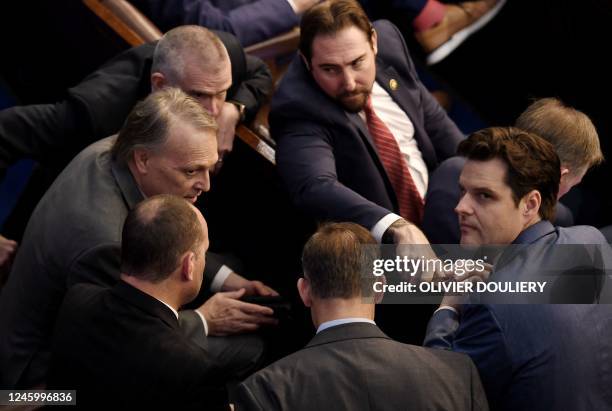 Representative Matt Gaetz looks up as US Representative Andy Biggs speaks to fellow members of the House of Representatives, as voting continues for...