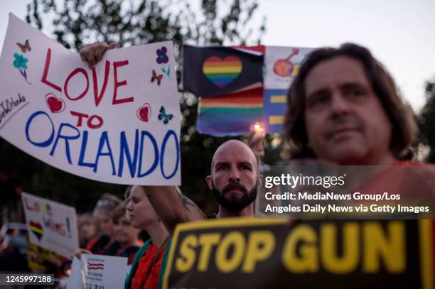 June 12: Christopher Vasquez, center, who in his early 20s spent time at the Orlando gay nightclub where 50 were killed, joins a vigil for the...