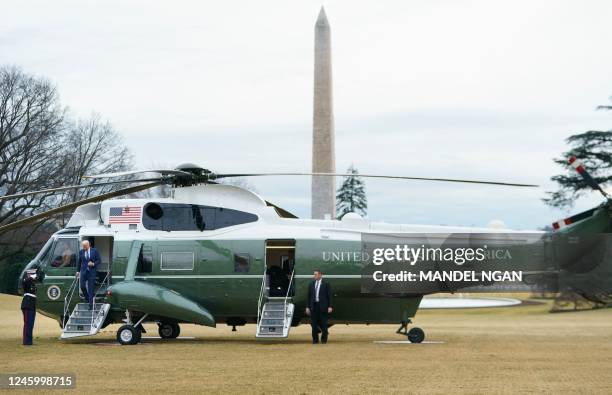 President Joe Biden disembarks Marine One on the South Lawn of the White House in Washington, DC, on January 4, 2023. - Biden is returning following...