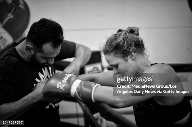 October 10: Coach Edmond Tarverdyan removes UFC women's bantamweight champion Ronda Rousey's gloves after sparring at the Glendale Fighting Club in...