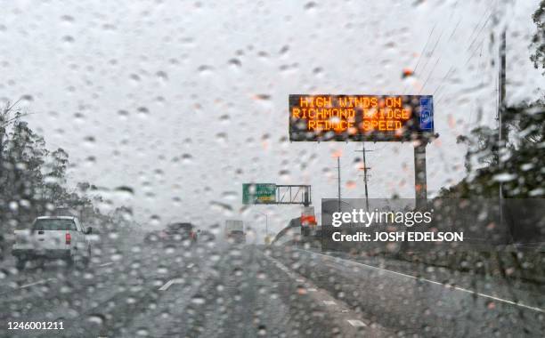 Traffic sign warns of inclement weather in San Rafael, California, on January 04, 2023. - A bomb cyclone smashed into California on January 4...