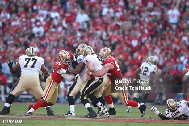 Justin Smith of the San Francisco 49ers sacks Drew Brees of the New Orleans Saints during the NFC divisional playoff game at Candlestick Park on...