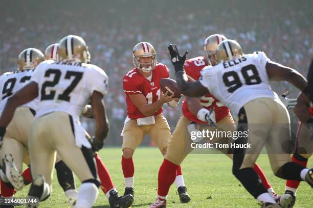 Alex Smith of the San Francisco 49ers takes the snap against the New Orleans Saints during the NFC divisional playoff game at Candlestick Park on...