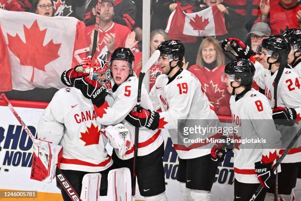 Brandt Clarke of Team Canada celebrates his goal by hugging goaltender Thomas Milic during the third period against Team United States in the...