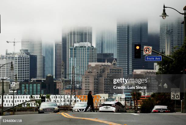Rain clouds shroud the skyline of downtown Los Angeles on a rainy Wednesday afternoon, Jan. 4, 2023. Another storm is expected to bring heavier rain...