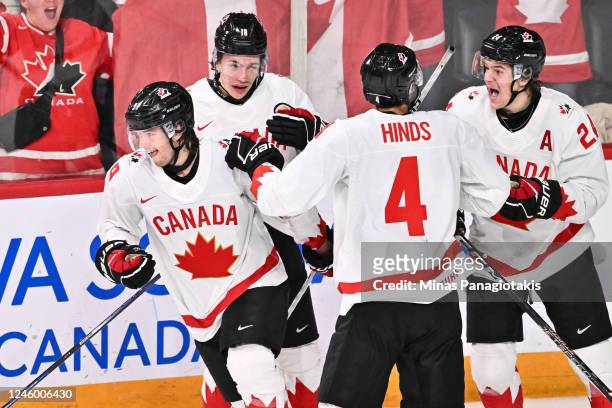 Joshua Roy of Team Canada skates off after celebrating his goal with teammates Caedan Bankier, Tyson Hinds, and Ethan del Mastro during the third...