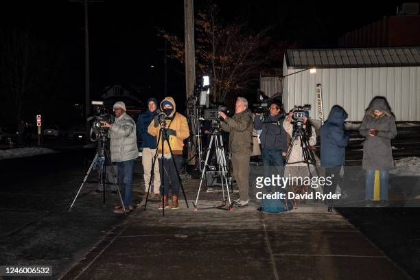 News media watch as a law enforcement convoy, believed to be carrying murder suspect Bryan Kohberger, approaches the Latah County Courthouse on...