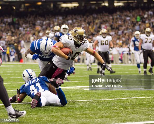 Jimmy Graham of the New Orleans Saints is tackled by Antoine Bethea ...