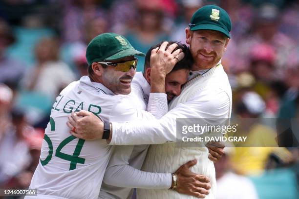 South Africas Keshav Maharaj celebrates the wicket of Australias Steve Smith with teammates during day two of the third cricket Test match between...