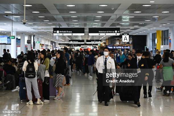 International travelers arrive at Sydney Airport in Sydney, Australia on January 5, 2023. Travelers from China will need to undergo mandatory testing...