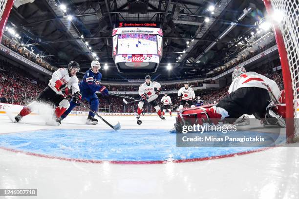Goaltender Thomas Milic tries to get back into position as teammate Nolan Allan of Team Canada skates after the puck against Jackson Blake of Team...