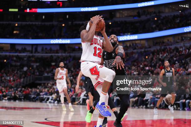 Brooklyn Nets Guard Kyrie Irving fouls Chicago Bulls Guard Ayo Dosunmu in action during a NBA game between the Brooklyn Nets and the Chicago Bulls on...