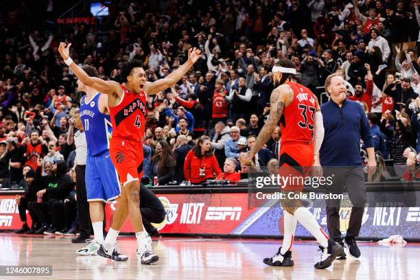 Scottie Barnes celebrates with Gary Trent Jr. #33 of the Toronto Raptors as Trent Jr. Hits a three-point shot to send their NBA game against the...