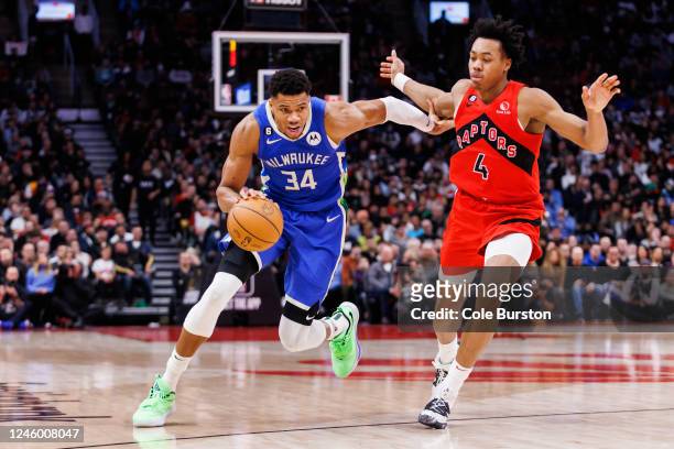 Giannis Antetokounmpo of the Milwaukee Bucks dribbles passed Scottie Barnes of the Toronto Raptors during the second half of their NBA game at...