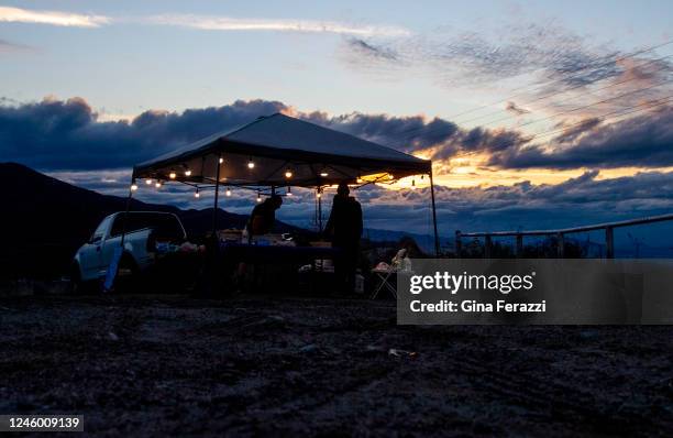 Dark storm clouds form in the background as a street vendor sells his carne asada off Highway 38 on January 4, 2022 in Mentone, California. The major...