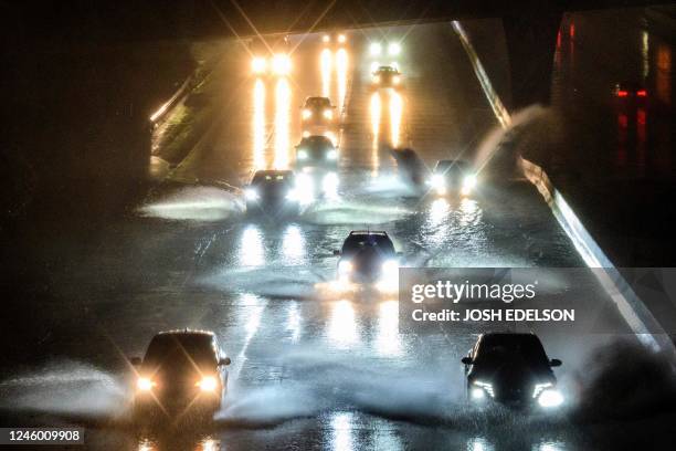 Drivers barrel into standing water on Interstate 101 in San Francisco, California on January 4, 2023. - A bomb cyclone smashed into California on...