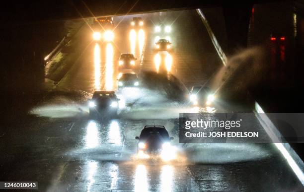 Drivers barrel into standing water on Interstate 101 in San Francisco, California on January 4, 2023. - A bomb cyclone smashed into California on...