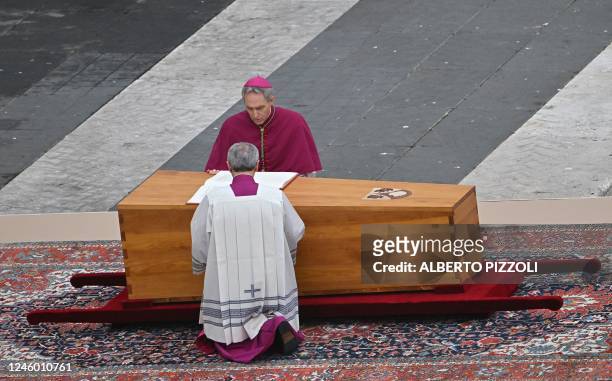Archbishop Georg Gaenswein pays his respect next to the coffin of Pope Emeritus Benedict XVI at the start of his funeral mass at St. Peter's square...