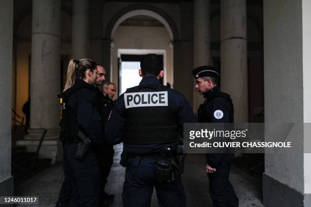 Policemen stand by in the courthouse during an extradition request hearing for Ukrainian businessman Kostiantin Jevago, at the Investigation Chamber...