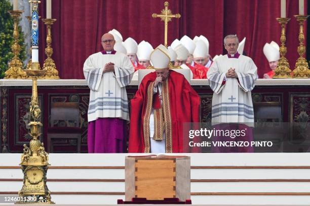 Pope Francis reacts by the coffin of Pope Emeritus Benedict XVI during his funeral mass at St. Peter's square in the Vatican, on January 5, 2023. -...