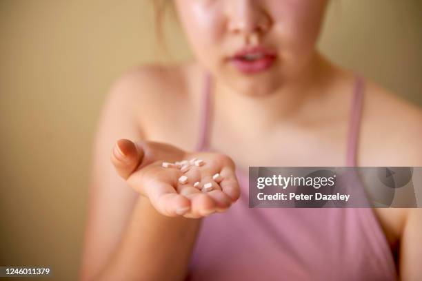 girl offering/selling party drugs - illegal drugs at work stock pictures, royalty-free photos & images