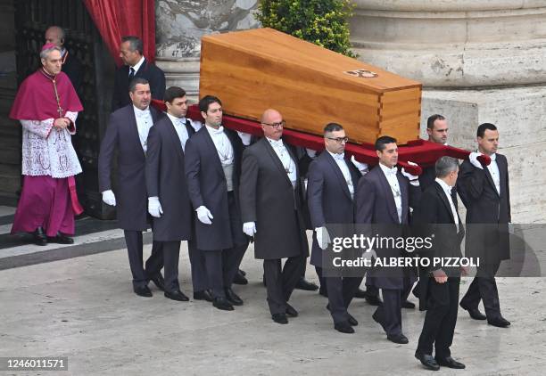 Pallbearers followed by German Archbishop Georg Gaenswein carry the coffin of Pope Emeritus Benedict XVI at the start of his funeral mass at St....