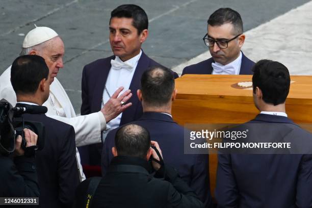 Pope Pope Francis pays his respetcs as he touches the coffin of Pope Emeritus Benedict XVI at the end of his funeral mass at St. Peter's square in...