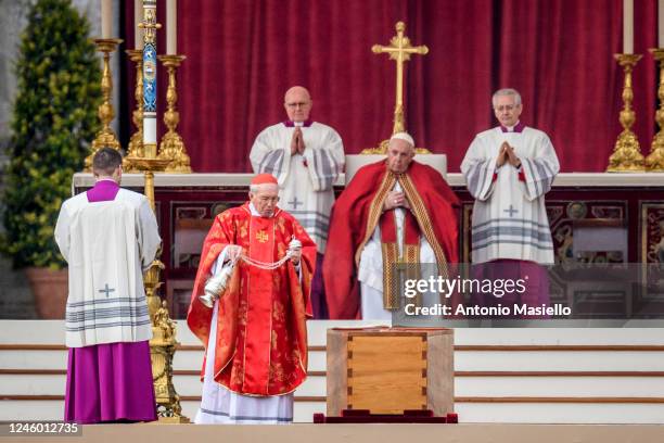 Cardinal Giovanni Battista Re swings a thurible of incense on the coffin of Pope Emeritus Benedict XVI during the funeral mass at St. Peter's square...