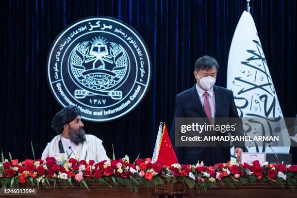 Afghanistan's acting first deputy prime minister Abdul Ghani Baradar and China's ambassador to Afghanistan Wang Yu attend a press conference to...