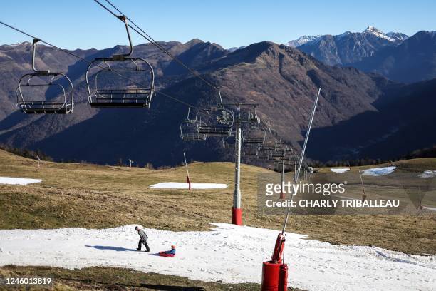 People sled on the remaining snow at the Luchon-Superbagneres ski resort, southwestern France, on January 5, 2023.