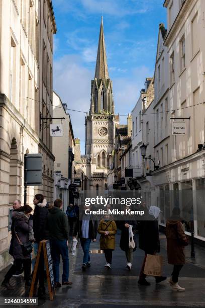 People including shoppers and visitors out and about on Green Street with St Michael's Church in the background where there are numerous boutique...