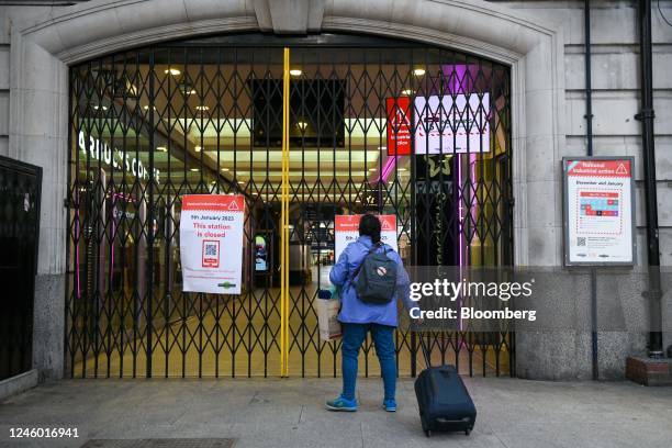 Traveller approaches closed gates at a station entrance, as train drivers represented by the Aslef union take part in strike action, at London...