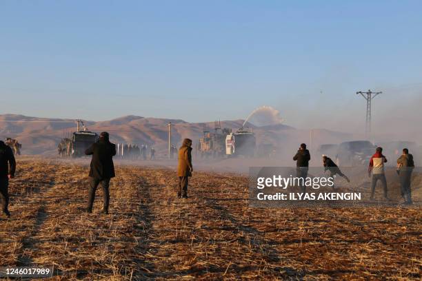 People clash with police as they try to attend the funeral of singer and political refugee Mir Perwer, one of three Kurds killed in a December 2022...
