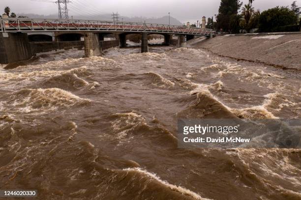 In an aerial view, the Los Angeles River flows at a powerful rate as a huge storm slams into the West Coast on January 5, 2023 in Los Angeles,...