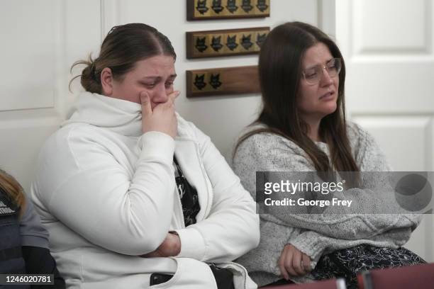 Two unidentified woman hold back tears at a news conference at city hall on the murder of eight people in the same family on January 5, 2023 in...