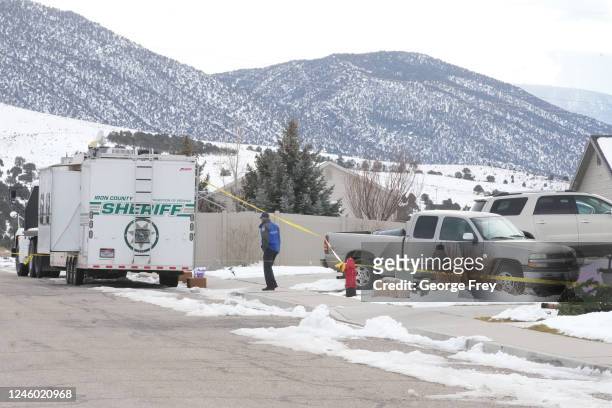 Police officer walks by a crime scene trailer that is sitting outside the home of Michael Haight on January 5, 2023 in Enoch, Utah. Haight, who was...