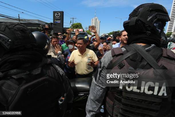 Police officers take measures as truck drivers stage a protest against the arrest of the Governor of Santa Cruz Luis Fernando Camacho in Santa Cruz,...