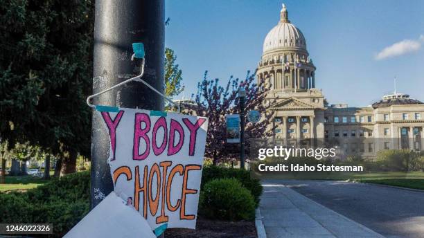 Sign taped to a hanger hangs near the Idaho Capitol in Boise after protests against the stateâs new abortion laws, which effectively banned the...