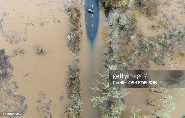 Vehicle turns around on a flooded road in Sebastopol, California, on January 05, 2023. Excessive rain, heavy snow and landslides are expected to...