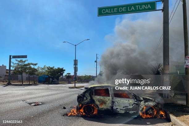 Burning car is seen on the street during an operation to arrest the son of Joaquin "El Chapo" Guzman, Ovidio Guzman, in Culiacan, Sinaloa state,...