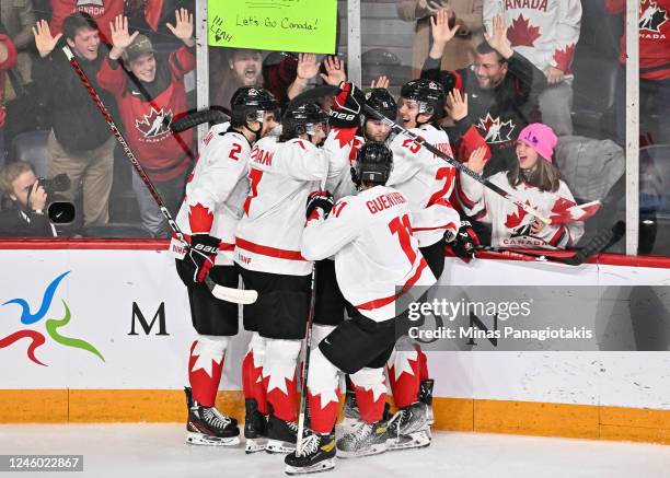 Shane Wright of Team Canada celebrates his goal with teammates Nolan Allan, Brennan Othmann, Dylan Guenther and Kevin Korchinski during the second...