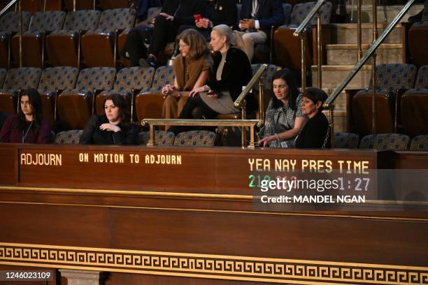 Onlookers watch as a board displays the vote count as members of the House of Representatives vote on a motion to adjourn, at the US Capitol in...
