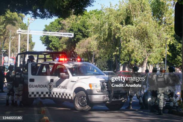 Federal forces take security measures outside the Special Prosecutor's Office before the departure of a convoy carrying Ovidio Guzman, the son of...