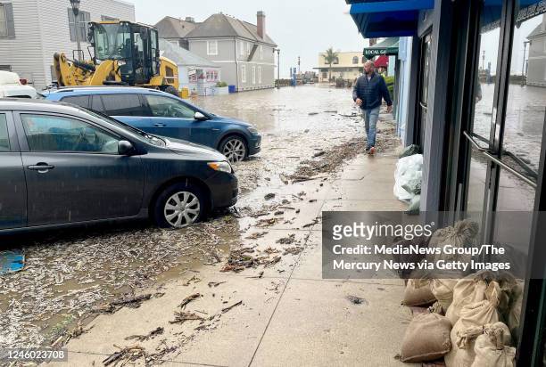 January 05: Josh Whitby, co-owner of Capitola Villages iconic waterfront Zeldas restaurant, walks through the flooded village.