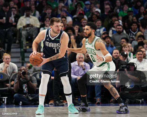 Jayson Tatum of the Boston Celtics guards Luka Doncic of the Dallas Mavericks during the game between the Boston Celtics and the Dallas Mavericks on...